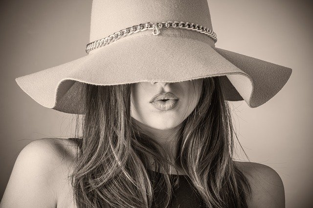 a beautiful classy woman or model in a hat