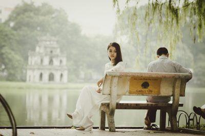 a man and a woman backing each other in sorrow