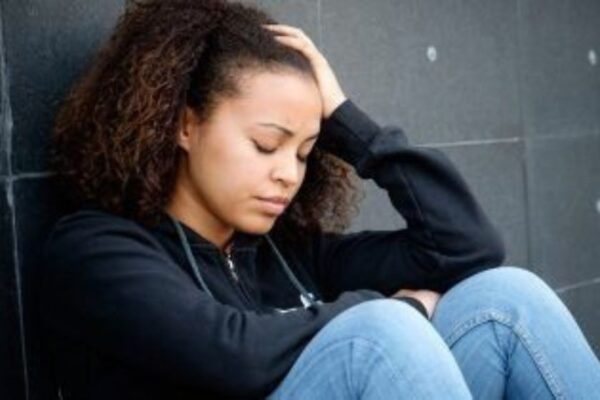 a woman sitting alone sad