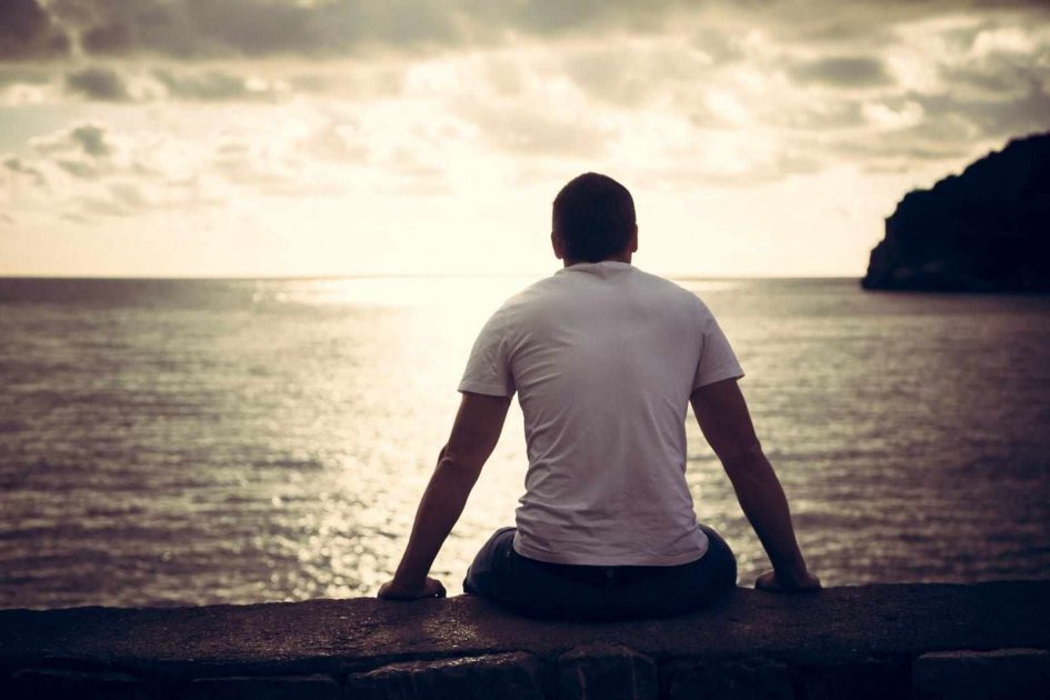 a black man sitting alone