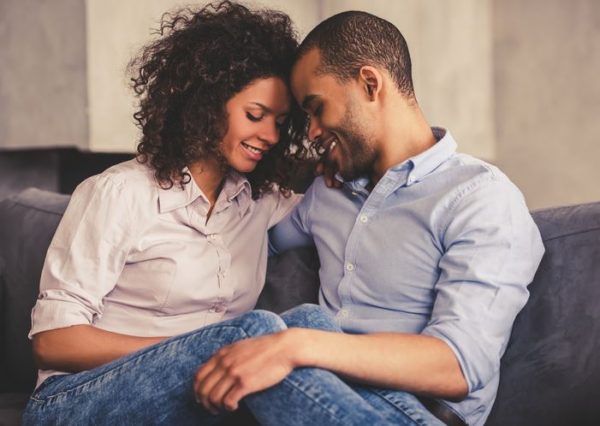 black couple in love cuddling at home