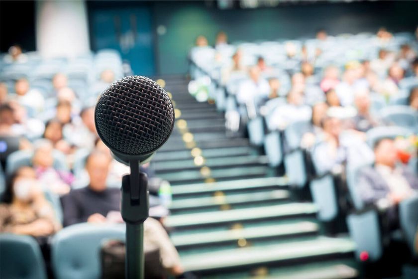 a motivational speaker public speaking with a microphone