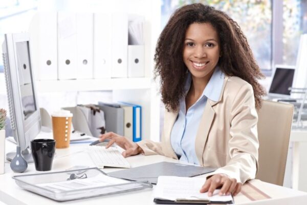 An African American woman at her office with a laptop
