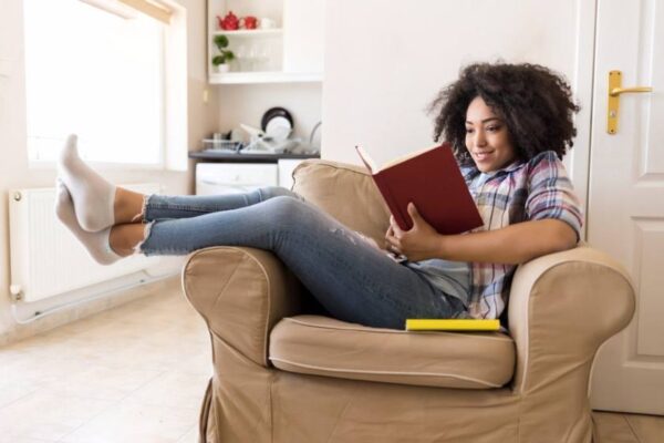 An African American woman reading at home