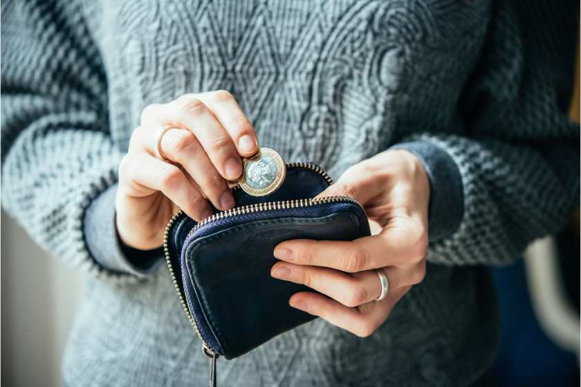 A woman bringing out money from her purse