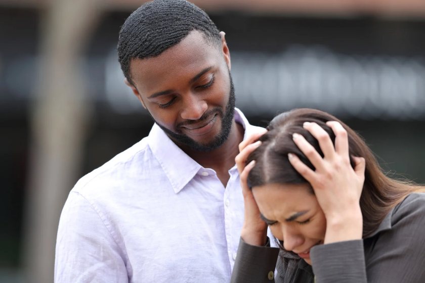 A black man comforting a sad woman