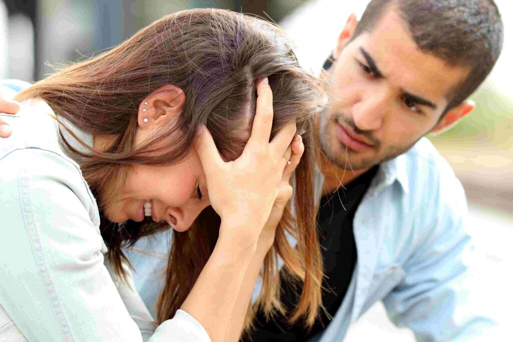 A sad and depressed woman being comforted by a man