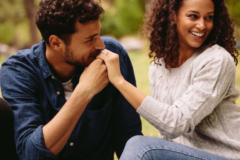 A man kissing the hands of a woman he loves