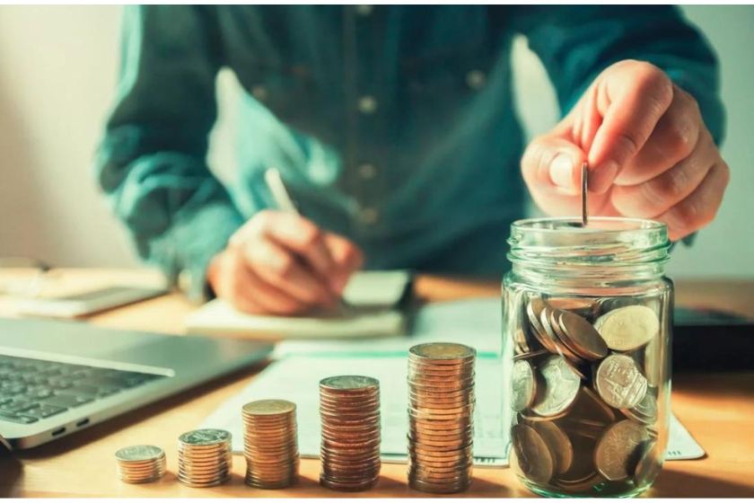 A man saving money one coins at a time - achieving financial freedom
